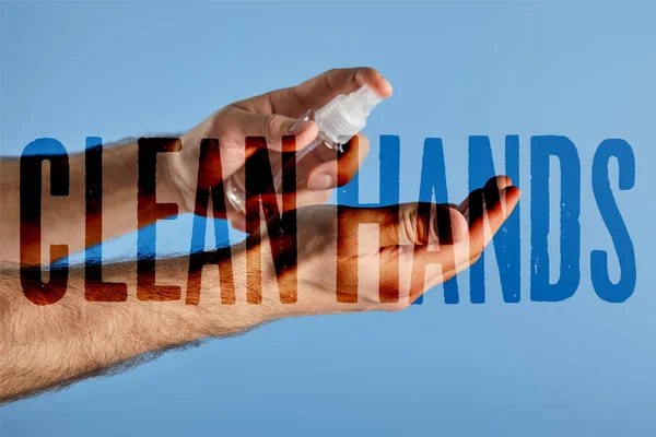 Cropped view of man using hand sanitizer in spray bottle isolated on blue, clean hands illustration — Stock Photo