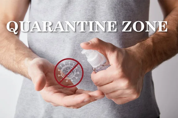 Cropped view of adult man using hand sanitizer in dispenser bottle, quarantine zone illustration — Stock Photo