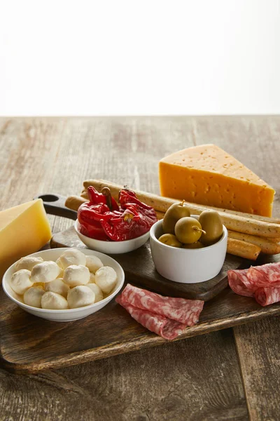 High angle view of antipasto ingredients on boards on wooden surface isolated on white — Stock Photo