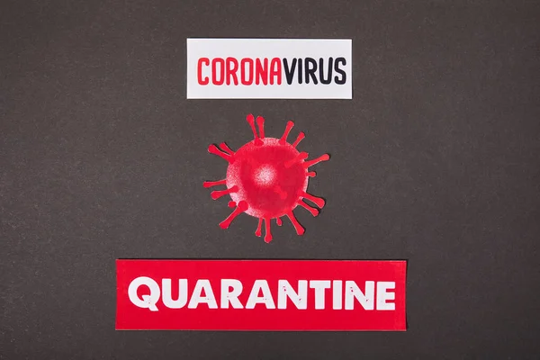 Top view of papers with quarantine and coronavirus lettering near drawn virus on black — Stock Photo