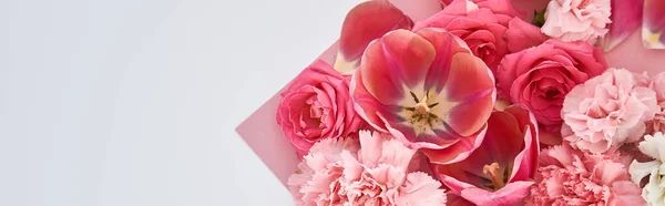 Top view of roses, tulips and carnations on pink and white background, panoramic shot — Stock Photo