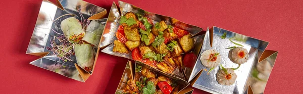 Panoramic crop of delicious chinese food in takeaway boxes on red — Stock Photo