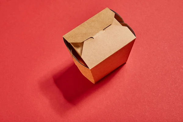 Top view of cardboard takeaway box on red — Stock Photo