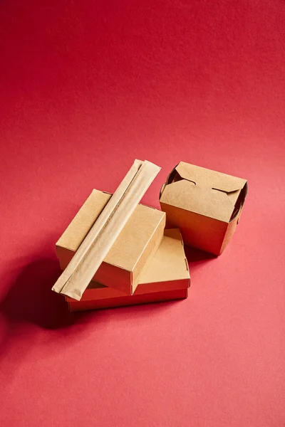 Top view of takeaway carton boxes with traditional chinese food on red — Stock Photo