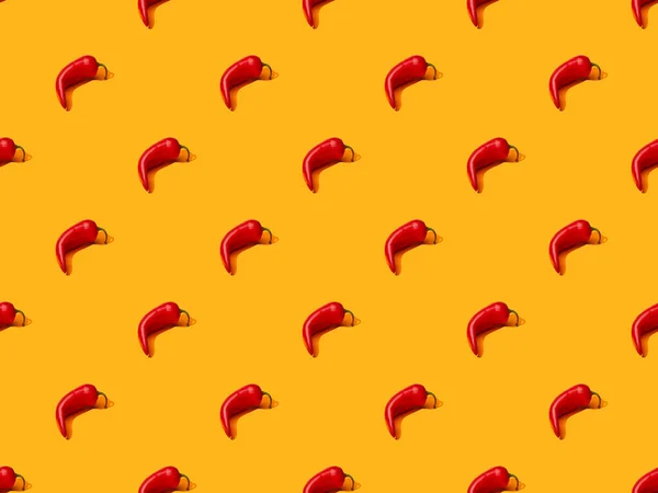 Red spicy chili peppers on orange colorful background, seamless pattern — Stock Photo