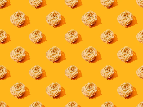 Fresh Tagliatelle on orange colorful background, seamless pattern — Stock Photo
