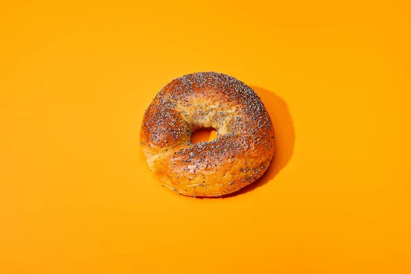 Fresh bun on orange colorful background — Stock Photo