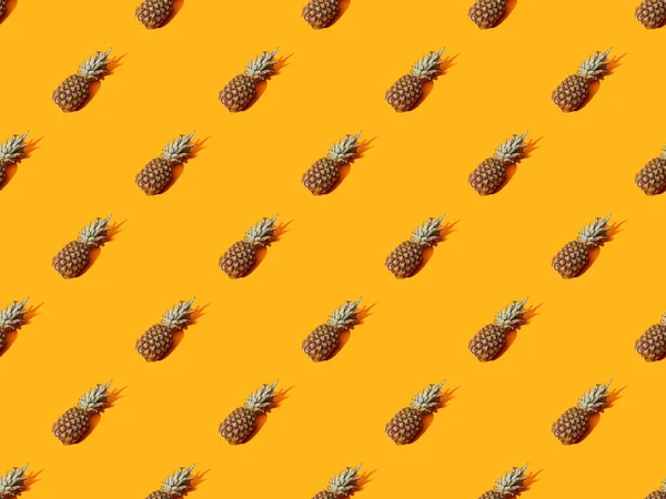 Ananas mûr entier sur fond orange coloré, motif sans couture — Photo de stock