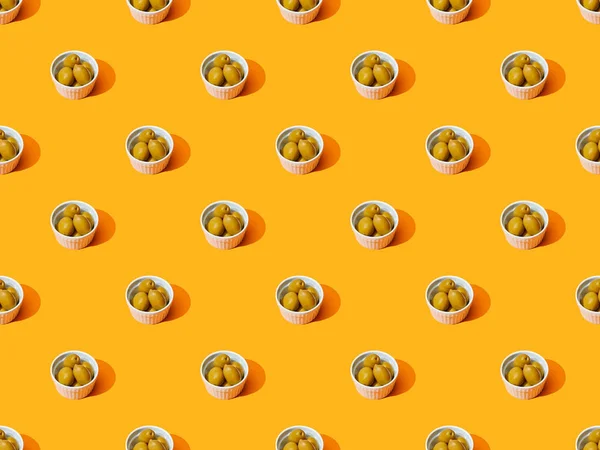 Olives in bowls on orange colorful background, seamless pattern — Stock Photo