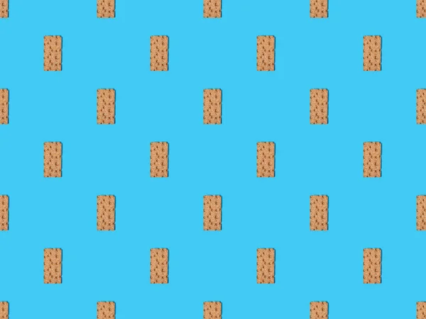 Top view of fresh crispbread on blue colorful background, seamless pattern — Stock Photo