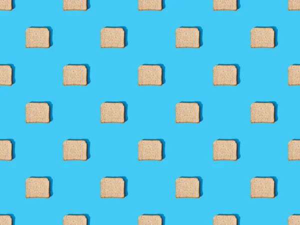 Top view of fresh toast bread on blue colorful background, seamless pattern — Stock Photo
