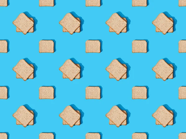 Top view of fresh toast bread on blue colorful background, seamless pattern — Stock Photo