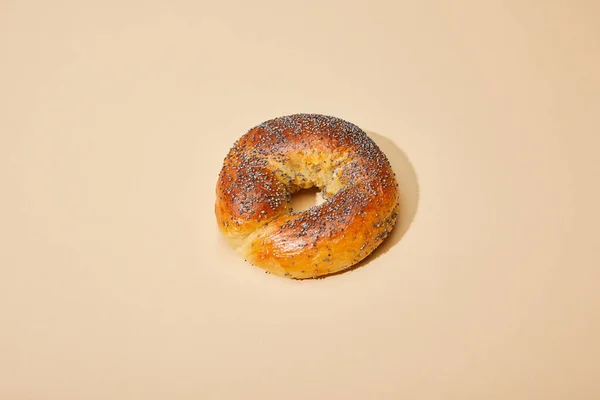 Fresh baked bun on beige background — Stock Photo