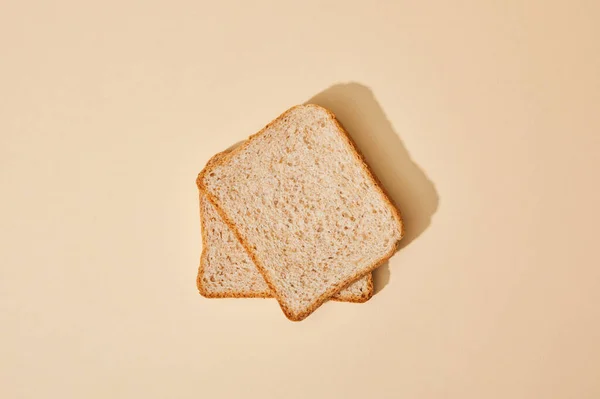 Top view of fresh toast bread on beige background — Stock Photo