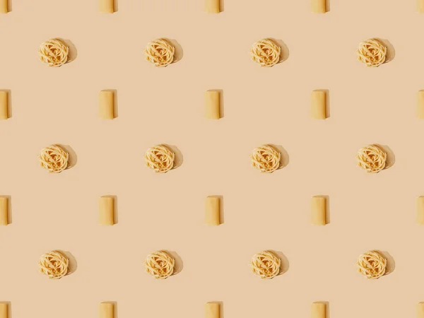 Top view of fresh pasta on beige background, seamless pattern — Stock Photo