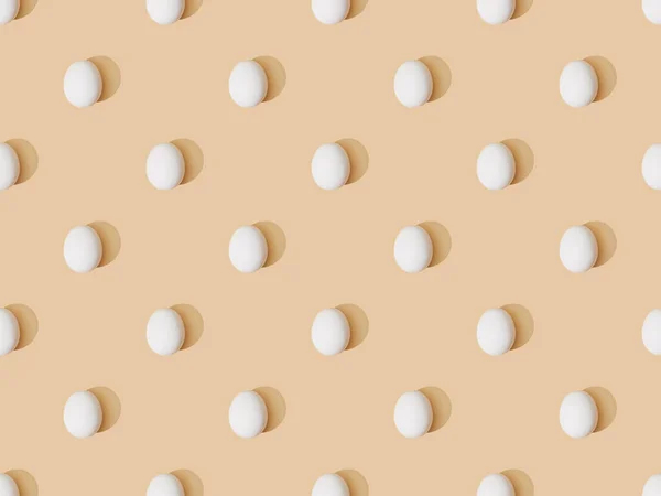 Top view of fresh chicken eggs on beige background, seamless pattern — Stock Photo