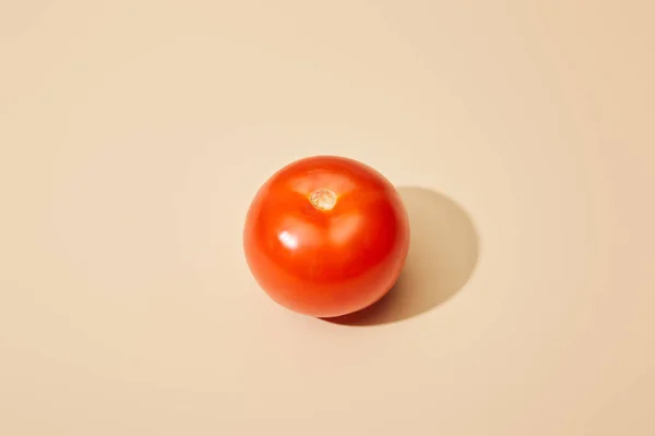 Ripe fresh tomato on beige background — Stock Photo