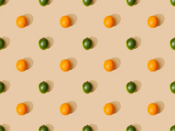 Top view of ripe oranges and limes on beige background, seamless pattern — Stock Photo