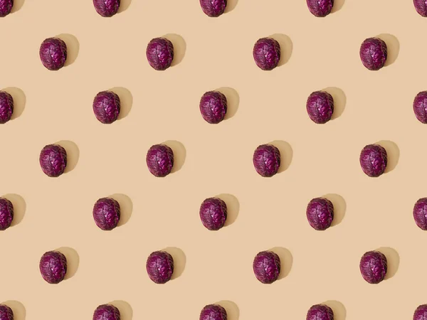Top view of whole ripe red cabbage on beige background, seamless pattern — Stock Photo