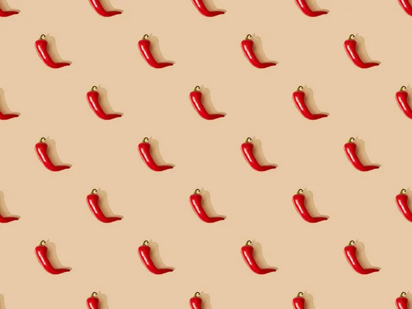 Top view of red spicy chili peppers on beige background, seamless pattern — Stock Photo