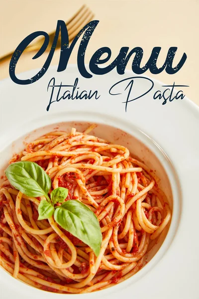 Selective focus of delicious spaghetti with tomato sauce in plate near fork on yellow background with Italian pasta menu illustration — Stock Photo