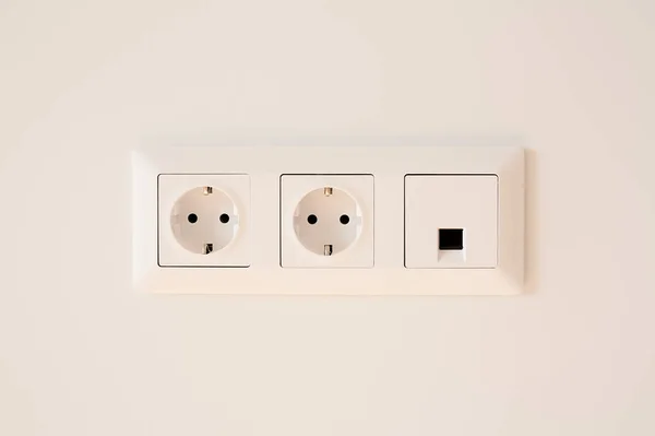 Switch near power plugs on white — Stock Photo