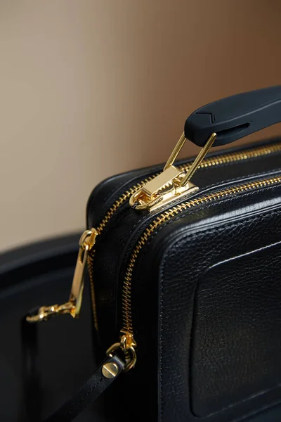 Close up view of leather handbag with golden zippers on beige background — Stock Photo