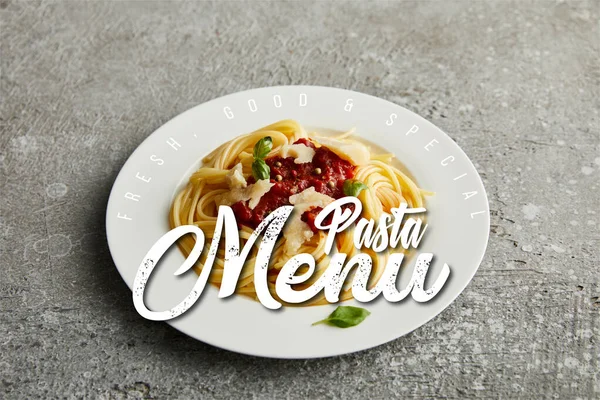 Tasty bolognese pasta with tomato sauce and Parmesan on white plate on grey background, pasta menu illustration — Stock Photo