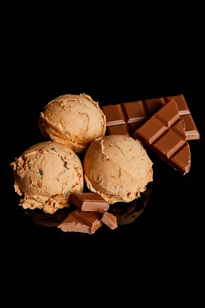 Fresh delicious chocolate ice cream isolated on black — Stock Photo