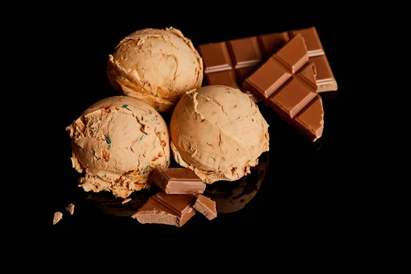 Fresh delicious chocolate ice cream isolated on black — Stock Photo