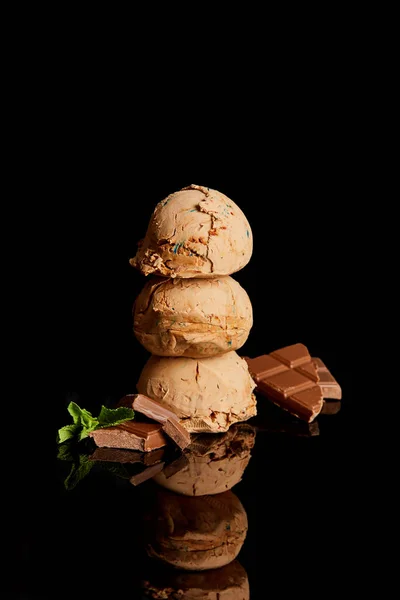 Fresh delicious chocolate ice cream with mint leaves isolated on black — Stock Photo