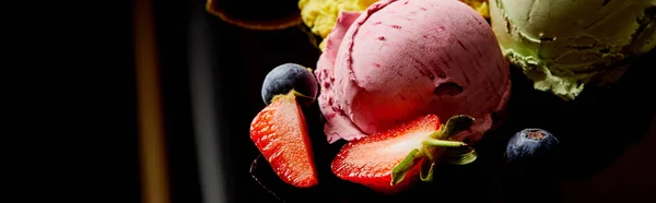 Close up view of delicious berry ice cream on black, panoramic orientation — Stock Photo