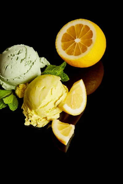 Fraîche délicieuse crème glacée citron et menthe isolé sur noir — Photo de stock