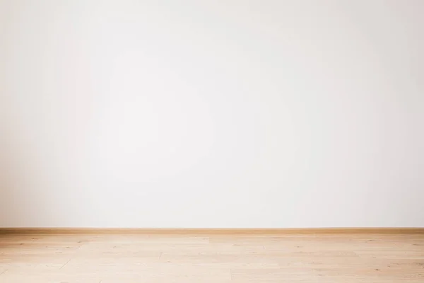 Grey empty wall and wooden beige floor — Stock Photo