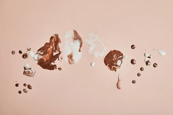 Top view of melted brown and white ice cream on pink background — Stock Photo