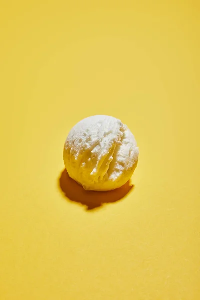Fresh tasty ice cream ball on yellow background — Stock Photo