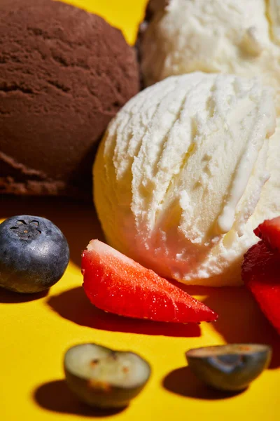Close up view of tasty brown and white ice cream with berries — Stock Photo