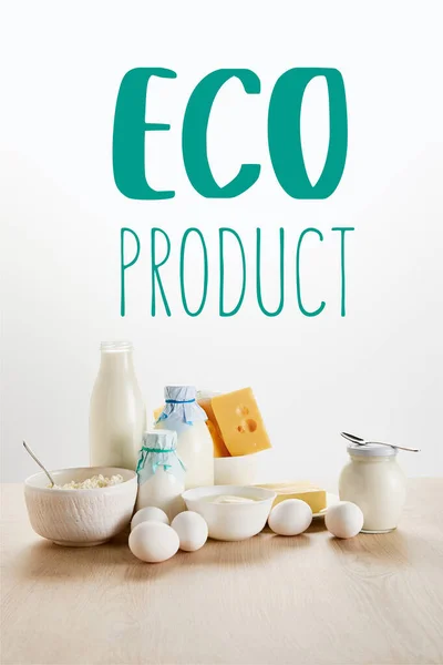 Delicious organic dairy products and eggs on wooden table isolated on white with eco product illustration — Stock Photo