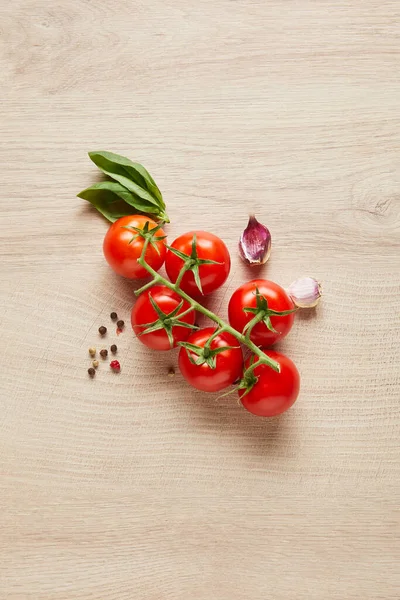 Top view of delicious tomatoes and spices on wooden table — Stock Photo