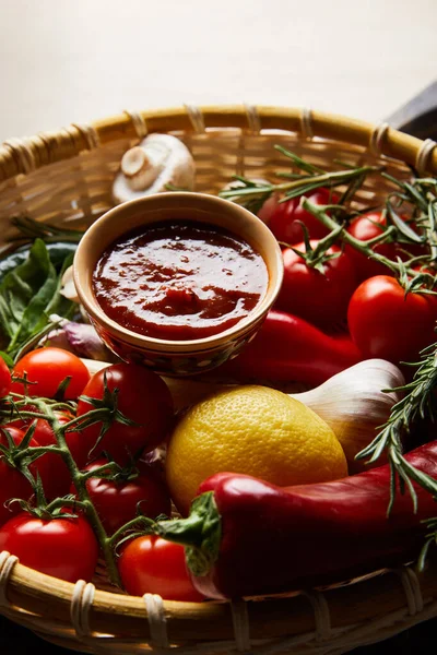 Deliciosa salsa de tomate con verduras frescas maduras en cesta - foto de stock
