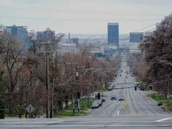 View of downtown Salt Lake City looking down 100 South from the University of Utah West towards the City in early spring March of 2018 along the Wasatch Front Rocky Mountains.