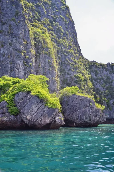 Island, Ocean views near Phuket Thailand with Blues, Turquoise and Greens oceans, mountains, boats, caves, trees resort island of phuket Thailand. Including Phi Phi, Ko Rang Yai, Ko Li Pe and other islands. Asia.