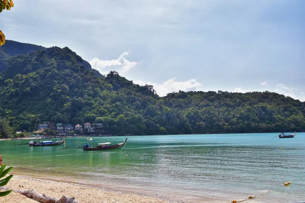 Island, Ocean views near Phuket Thailand with Blues, Turquoise and Greens oceans, mountains, boats, caves, trees resort island of phuket Thailand. Including Phi Phi, Ko Rang Yai, Ko Li Pe and other islands. Asia.