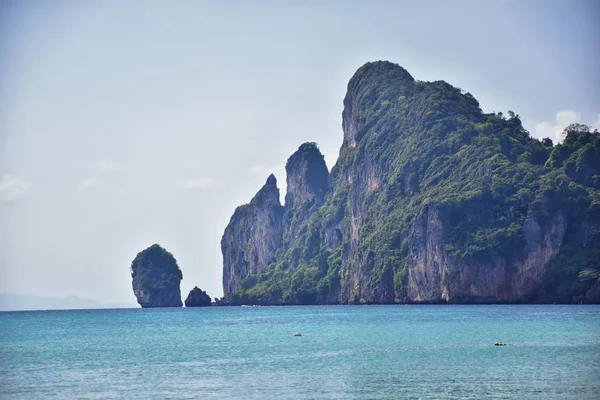 Island, Ocean views near Phuket Thailand with Blues, Turquoise and Greens oceans, mountains, boats, caves, trees resort island of phuket Thailand. Including Phi Phi, Ko Rang Yai, Ko Li Pe and other islands. Asia.