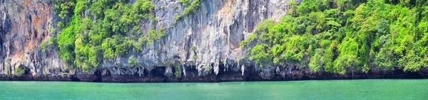 Island, Ocean views near Phuket Thailand with Blues, Turquoise and Greens oceans, mountains, boats, caves, trees resort island of phuket Thailand. Including Phi Phi, Ko Rang Yai, Ko Li Pe and other islands. Asia.