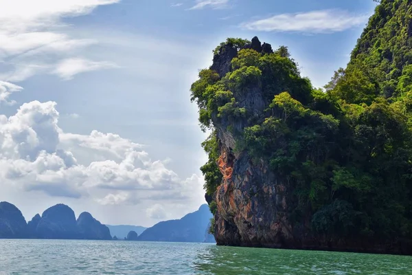 Island, Ocean views near Phuket Thailand with Blues, Turquoise and Greens oceans, mountains, boats, caves, trees resort island of phuket Thailand. Including Phi Phi, Ko Rang Yai, Ko Li Pe and other islands. Asia.