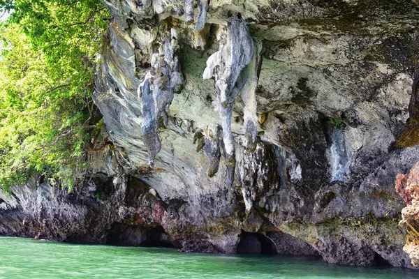 Island, Ocean views near Phuket Thailand with Blues, Turquoise and Greens oceans, mountains, boats, caves, trees resort island of phuket Thailand. Including Phi Phi, Ko Rang Yai, Ko Li Pe and other islands. Asia.