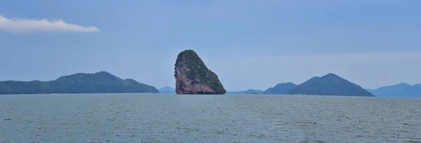 Island, Ocean views near Phuket Thailand with Blues, Turquoise and Greens oceans, mountains, boats, caves, trees resort island of phuket Thailand. Including Phi Phi, Ko Rang Yai, Ko Li Pe and other islands. Asia.