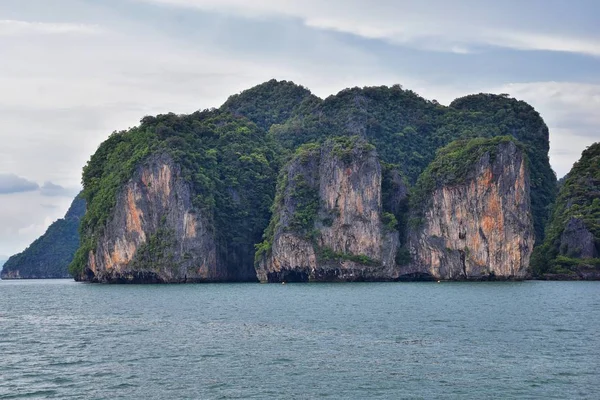 Island, Ocean views near Phuket Thailand with Blues, Turquoise and Greens oceans, mountains, boats, caves, trees resort island of phuket Thailand. Including Phi Phi, Ko Rang Yai, Ko Li Pe and other islands. Asia.