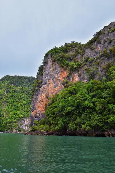 Island, Ocean views near Phuket Thailand with Blues, Turquoise and Greens oceans, mountains, boats, caves, trees resort island of phuket Thailand. Including Phi Phi, Ko Rang Yai, Ko Li Pe and other islands. Asia.